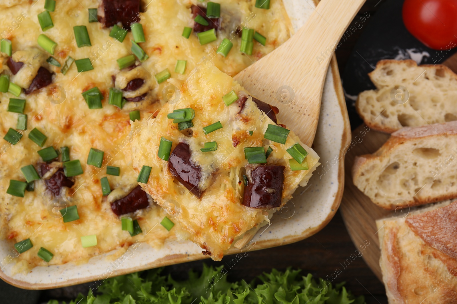 Photo of Tasty sausage casserole served on table, flat lay