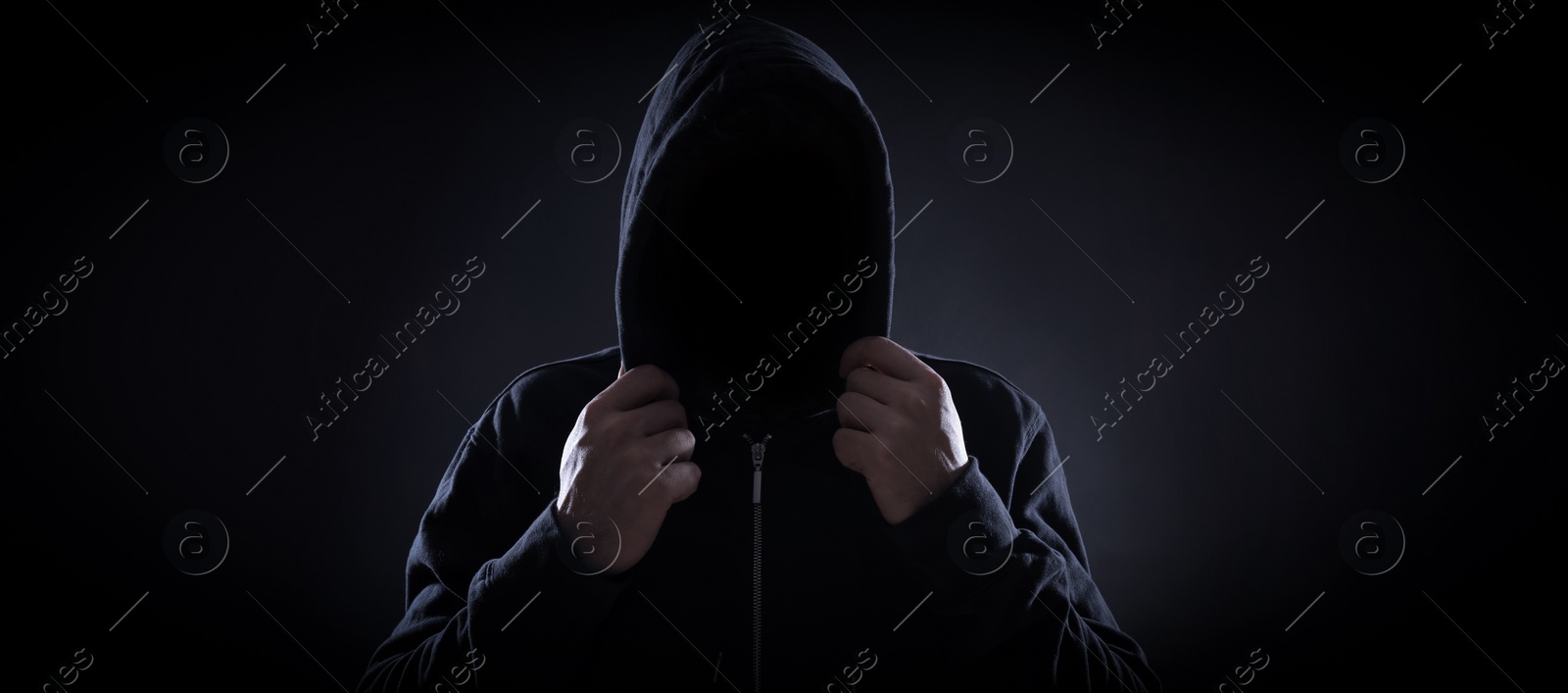 Image of Anonymous man in hood on black background. Banner design