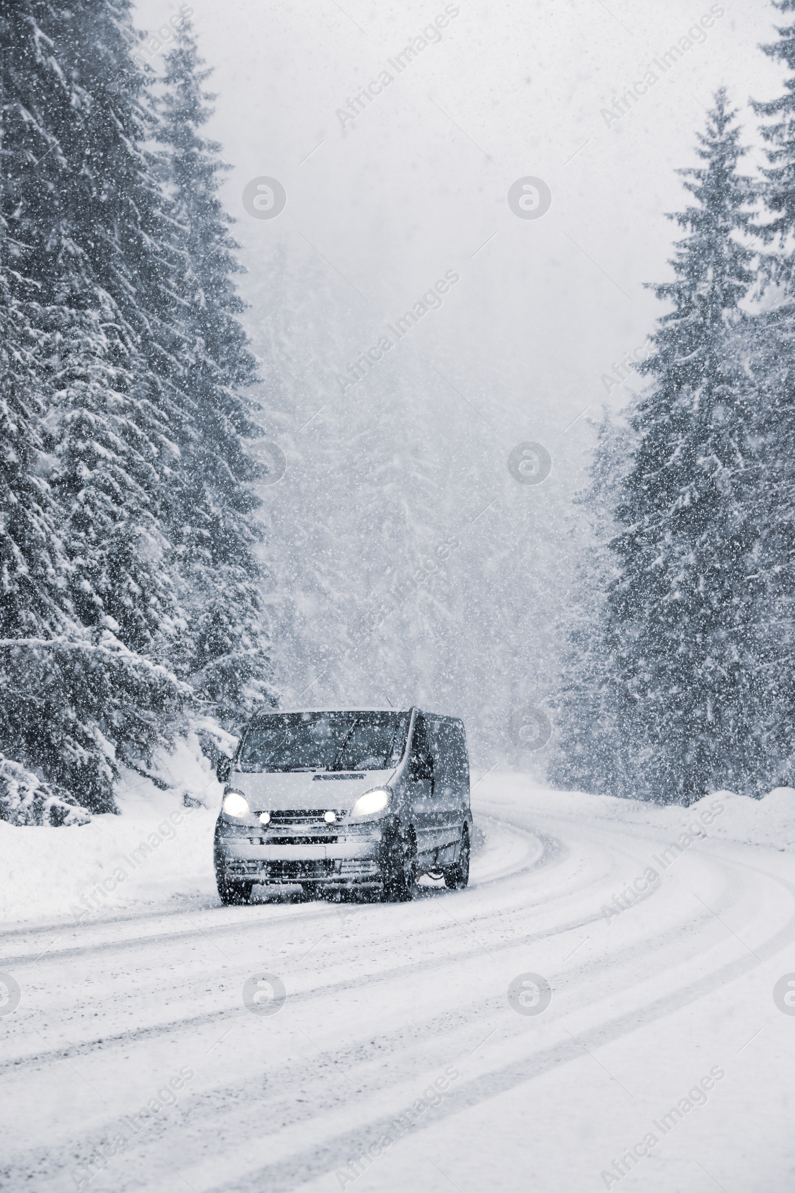 Photo of Snowy country road with modern car on winter day