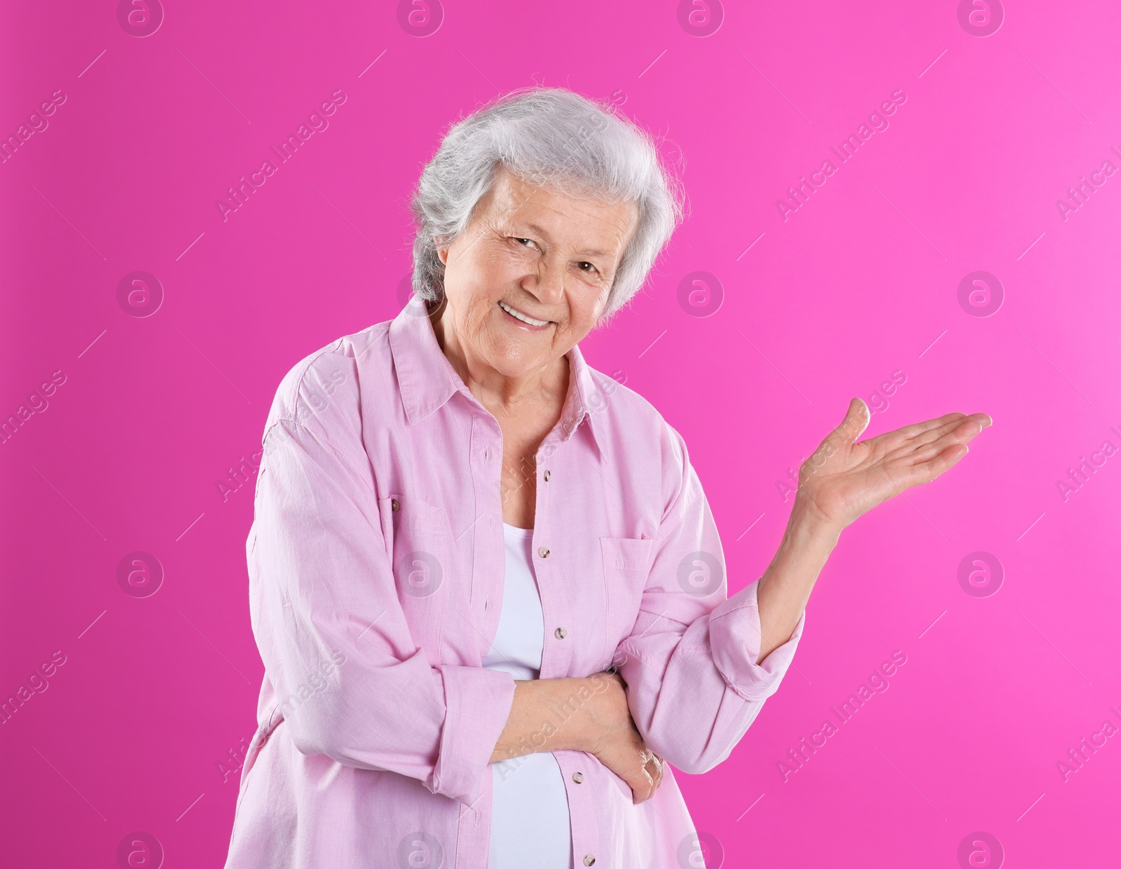 Photo of Portrait of grandmother in stylish clothes on color background