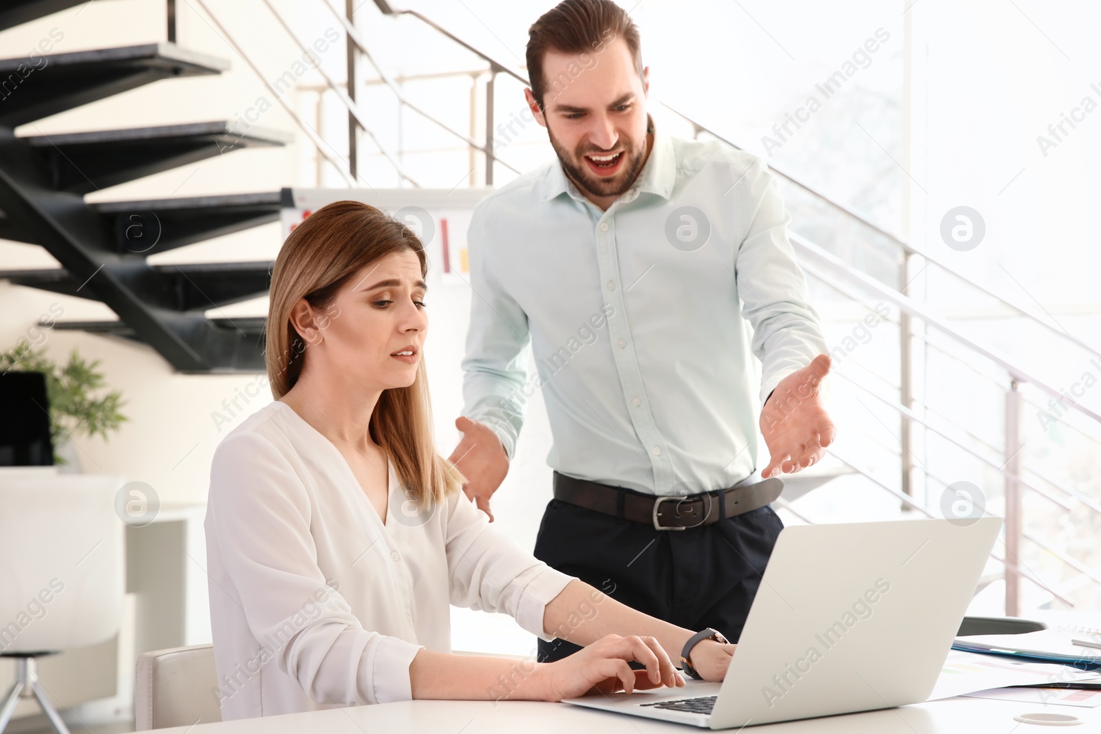 Photo of Office employees having argument at workplace