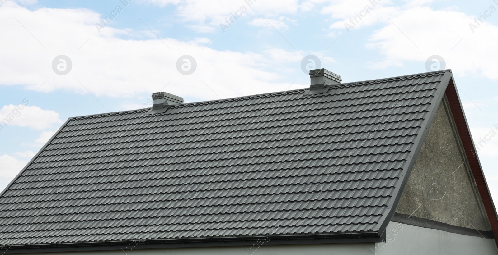 Photo of Modern building with grey roof outdoors on spring day