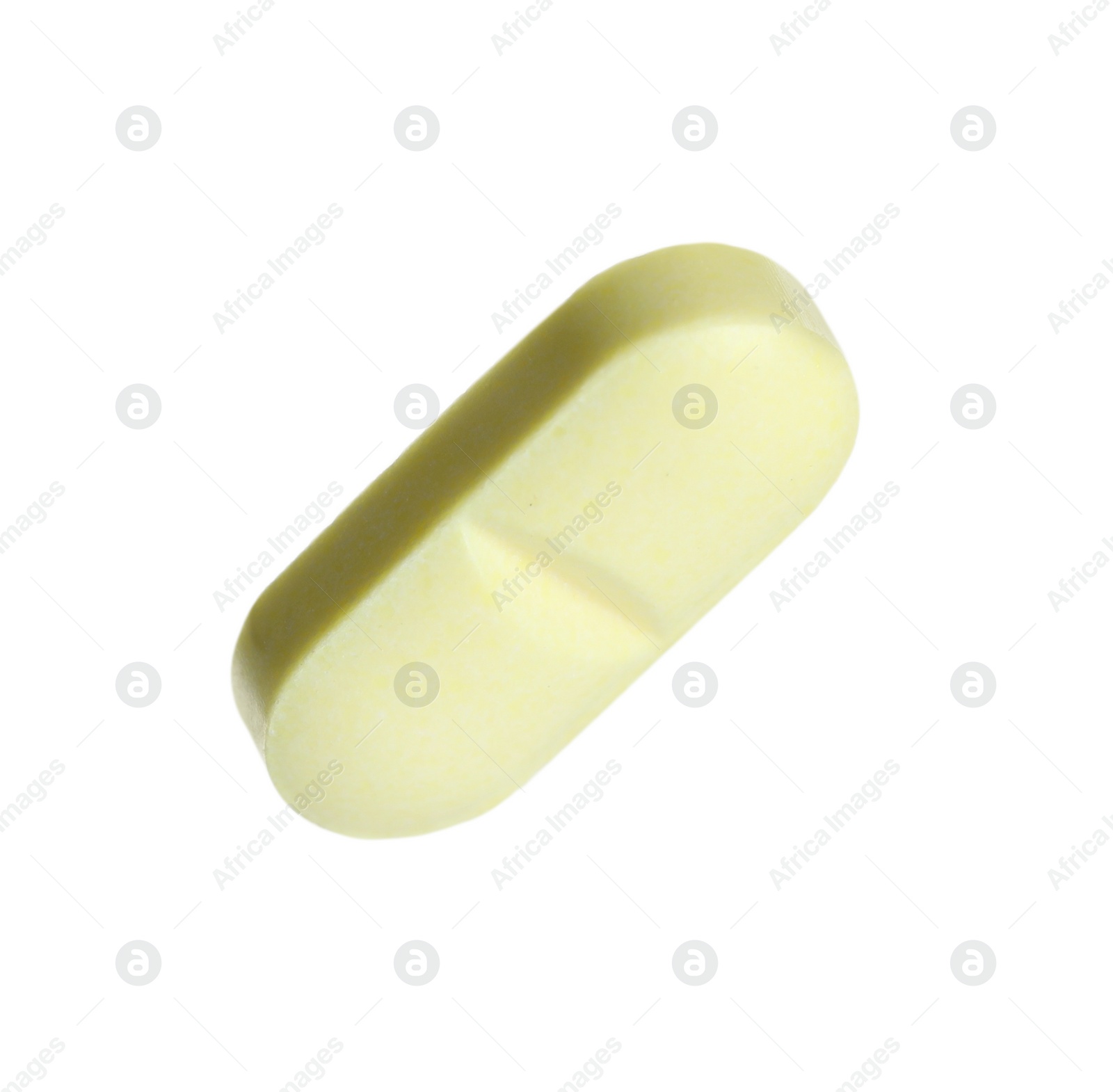 Photo of One light green pill on white background. Medicinal treatment