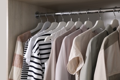 Photo of Wardrobe with different stylish clothes indoors, closeup