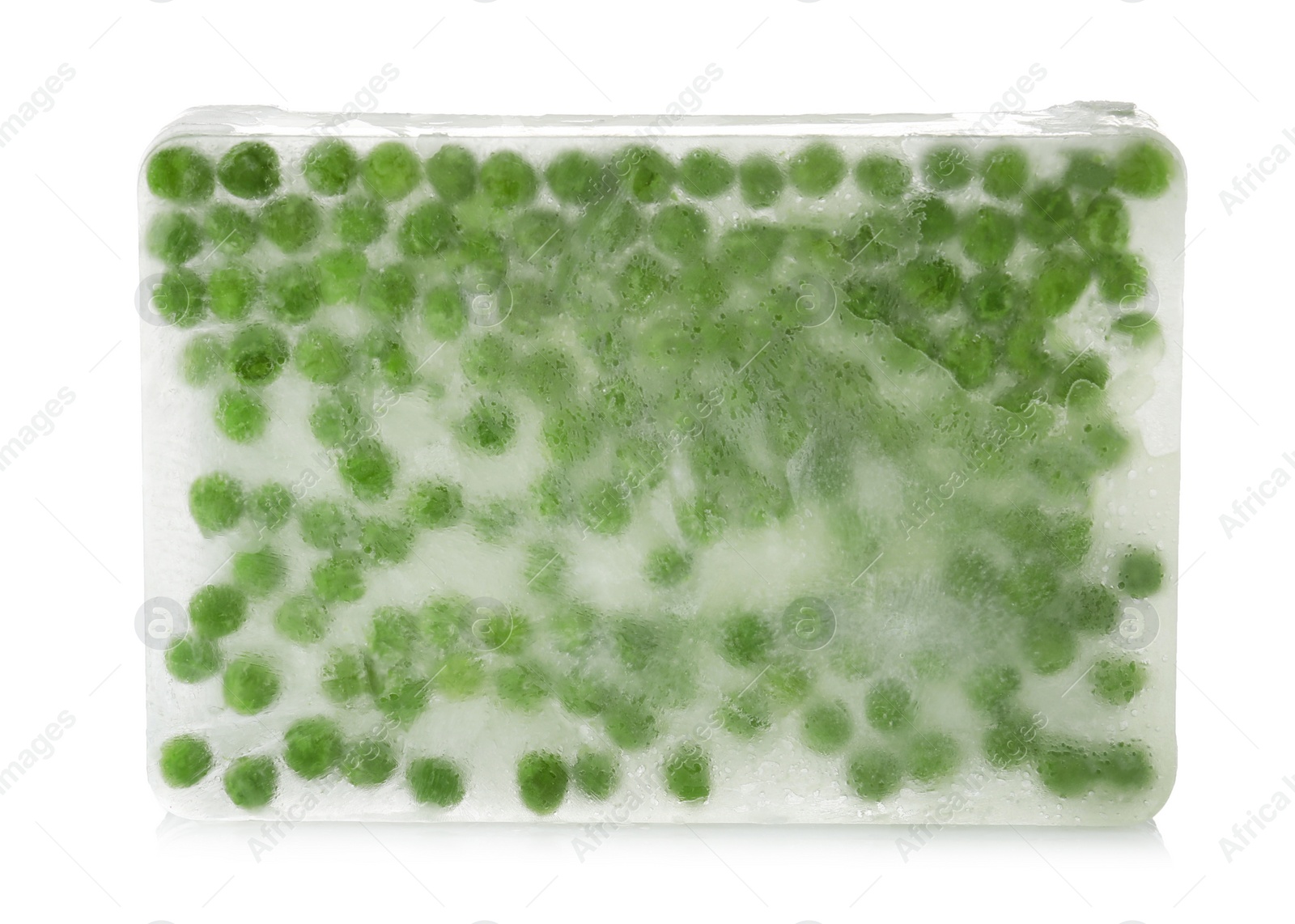 Photo of Green peas in ice cube on white background. Frozen vegetables