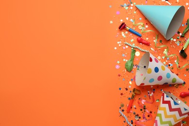 Photo of Beautiful flat lay composition with festive items on orange background, space for text. Surprise party concept