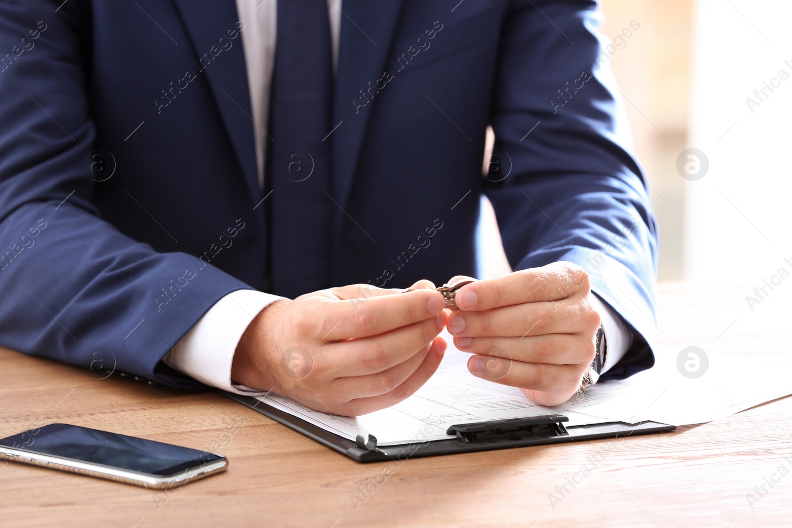 Photo of Real estate agent at table in office, closeup