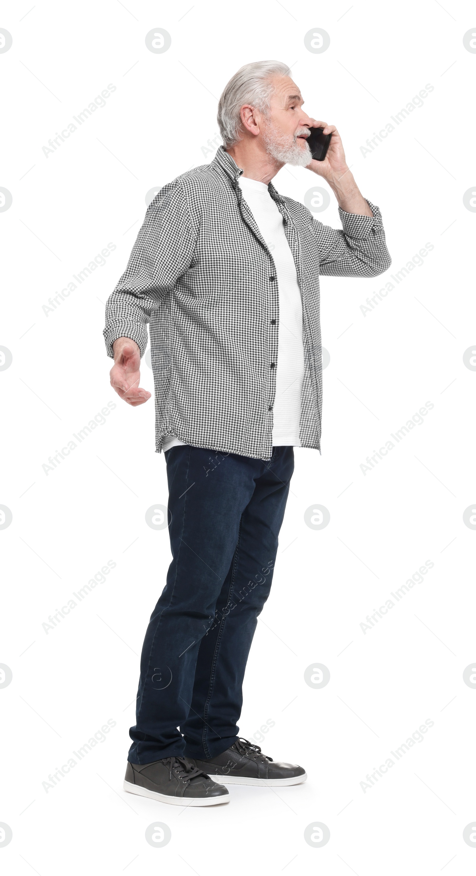 Photo of Senior man talking on smartphone against white background