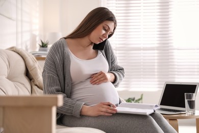 Pregnant woman working on sofa at home. Maternity leave