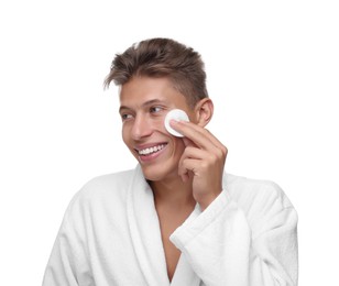 Handsome man cleaning face with cotton pad on white background
