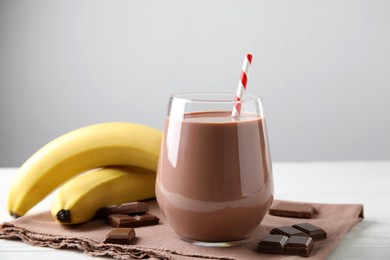 Photo of Yummy chocolate milk and fresh ingredients on white table