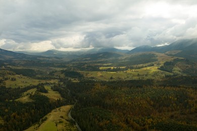 Aerial view of beautiful forest and mountain village on autumn day