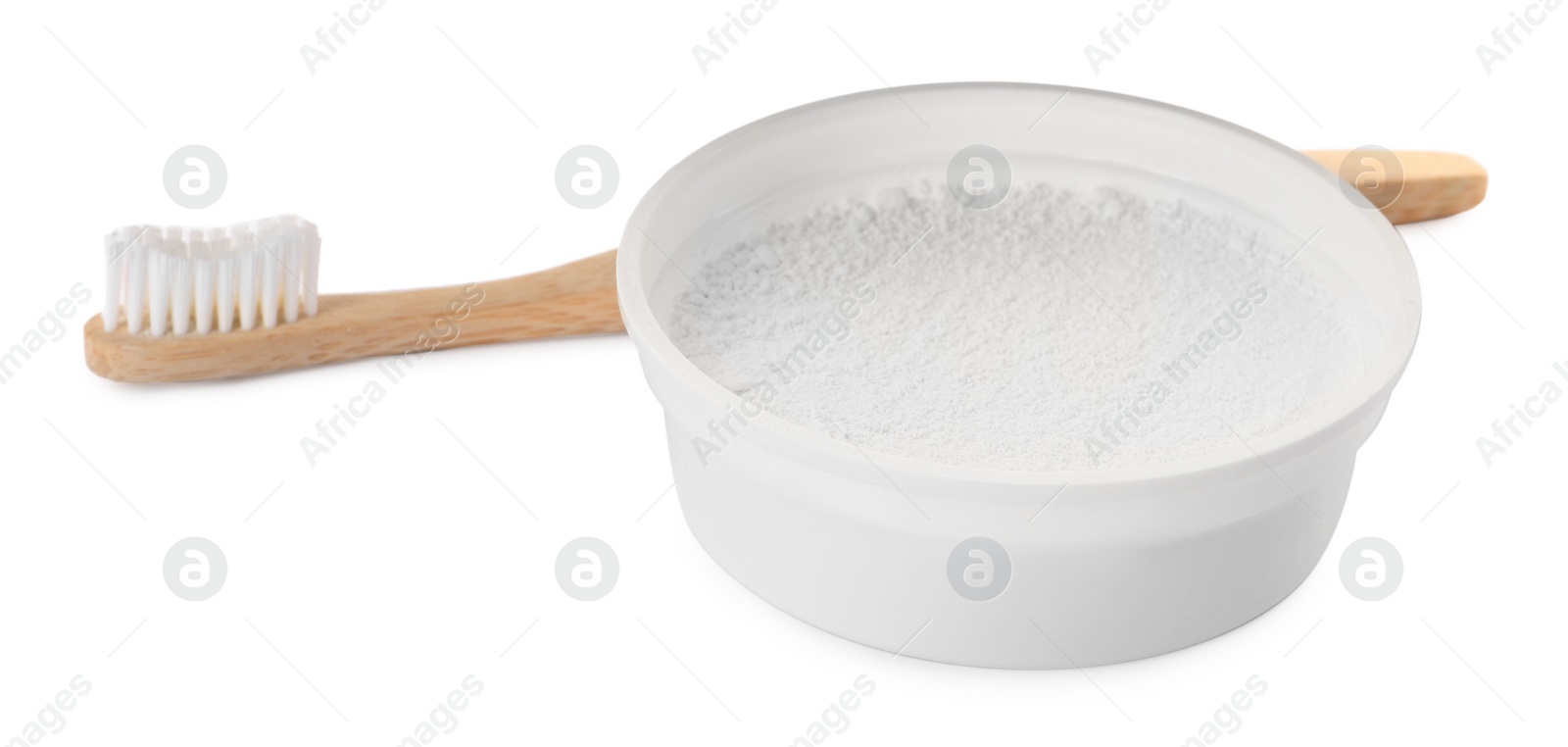 Photo of Bowl of tooth powder and brush on white background