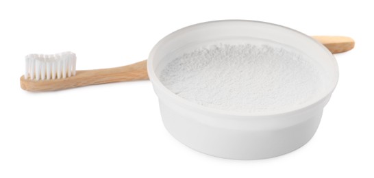 Photo of Bowl of tooth powder and brush on white background