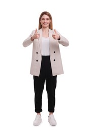 Beautiful happy businesswoman showing thumbs up on white background