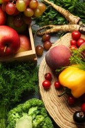 Different fresh vegetables and fruits on grey wooden table, flat lay. Farmer harvesting