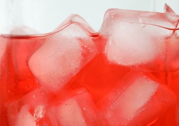 Photo of Closeup view of cold refreshing drink with ice in glass