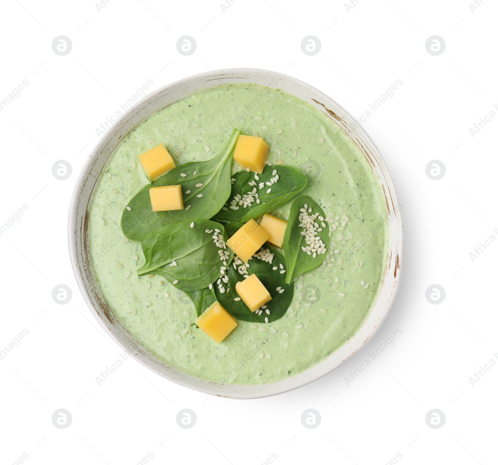 Photo of Delicious spinach cream soup with cheese and sesame seeds in bowl isolated on white, top view