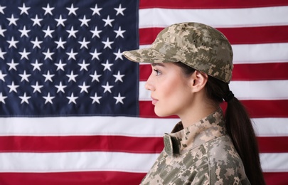 Photo of Female soldier in uniform against United states of America flag