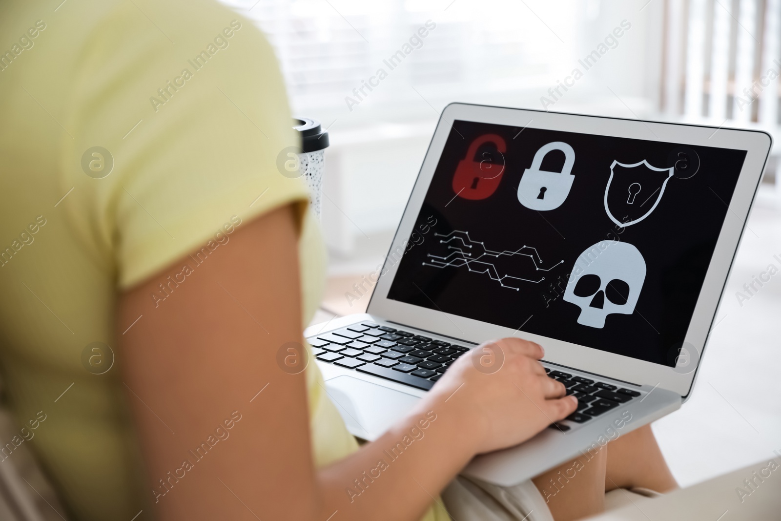 Photo of Woman holding laptop with virus illustration on screen at home, closeup