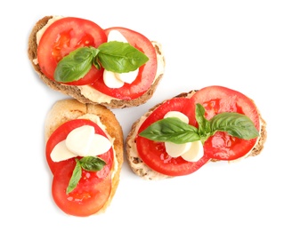 Photo of Tasty fresh tomato bruschettas on white background, top view