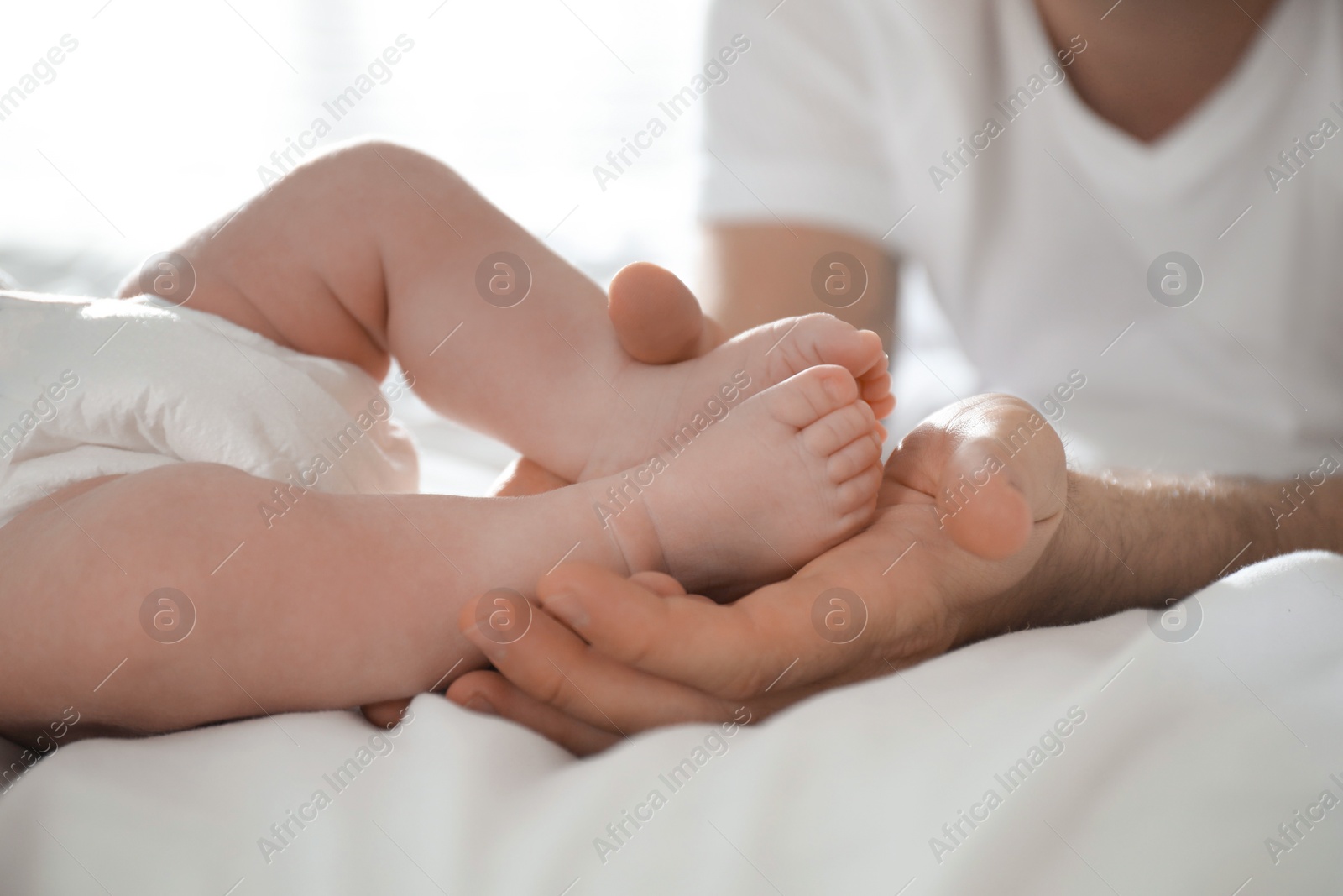 Photo of Father with his newborn son at home, closeup