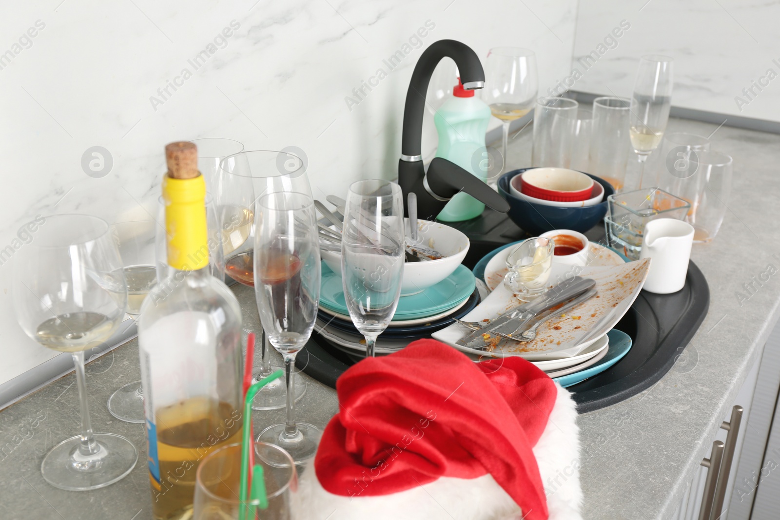 Photo of Pile of dirty dishes in kitchen after party