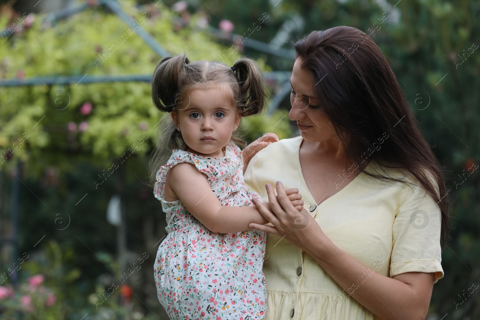 Photo of Mother with her cute daughter spending time together in park