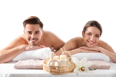 Photo of Young couple with spa essentials in wellness center