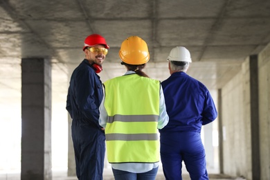 Professional engineers in safety equipment at construction site
