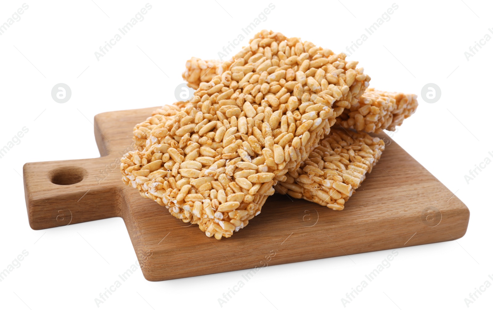 Photo of Wooden board with puffed rice bars (kozinaki) on white background