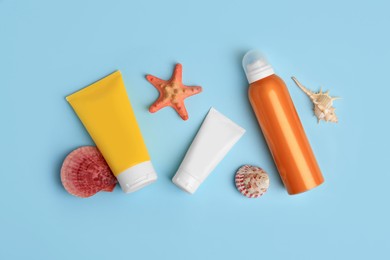 Photo of Flat lay composition with sunscreen on light blue background. Sun protection