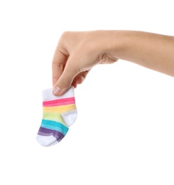Photo of Woman holding cute child sock on white background, closeup