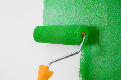 Photo of Painting white wall with green dye, closeup. Interior renovation