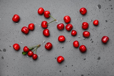 Flat lay composition with sweet red cherries on color background