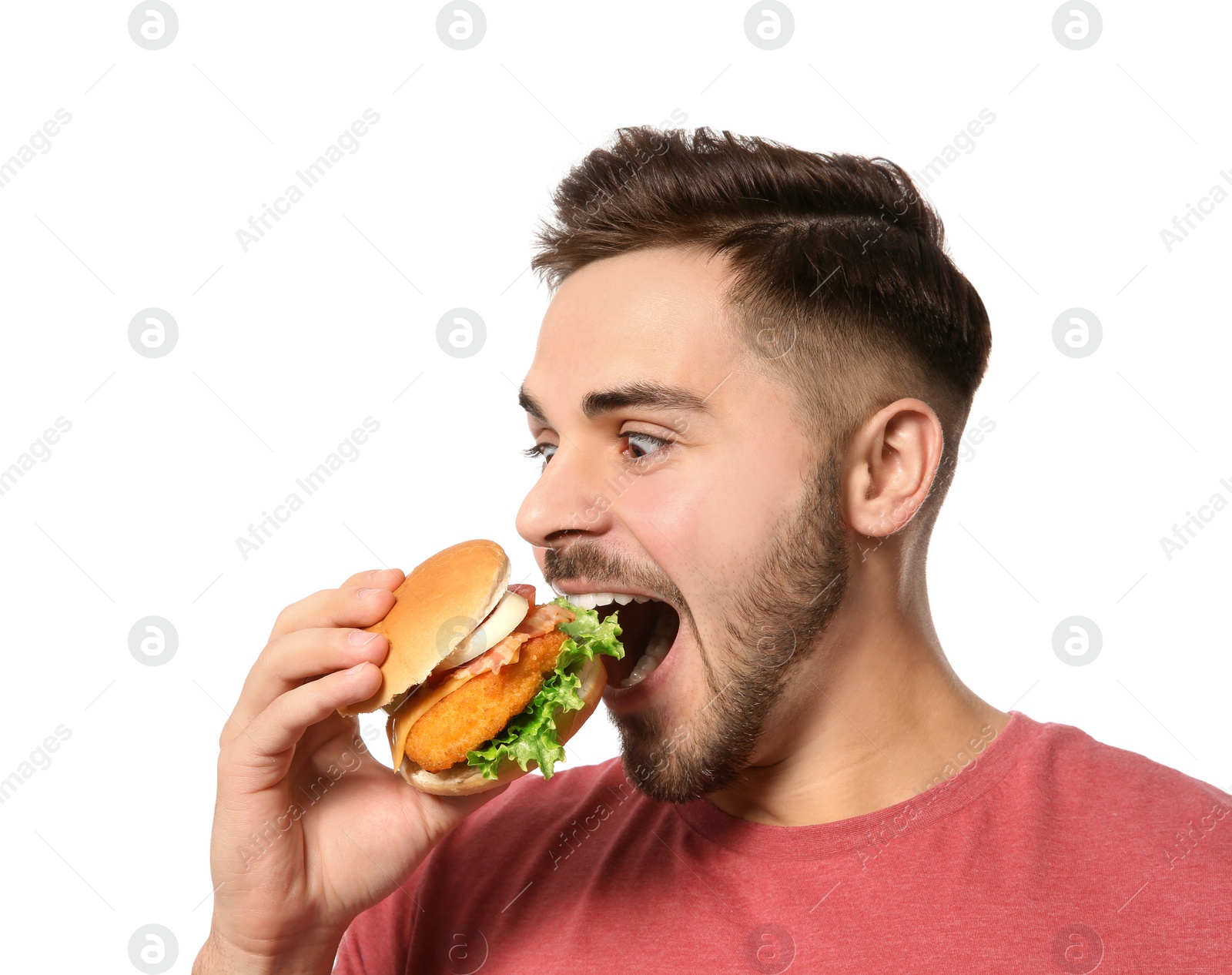 Photo of Handsome man eating tasty burger isolated on white