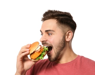 Photo of Handsome man eating tasty burger isolated on white