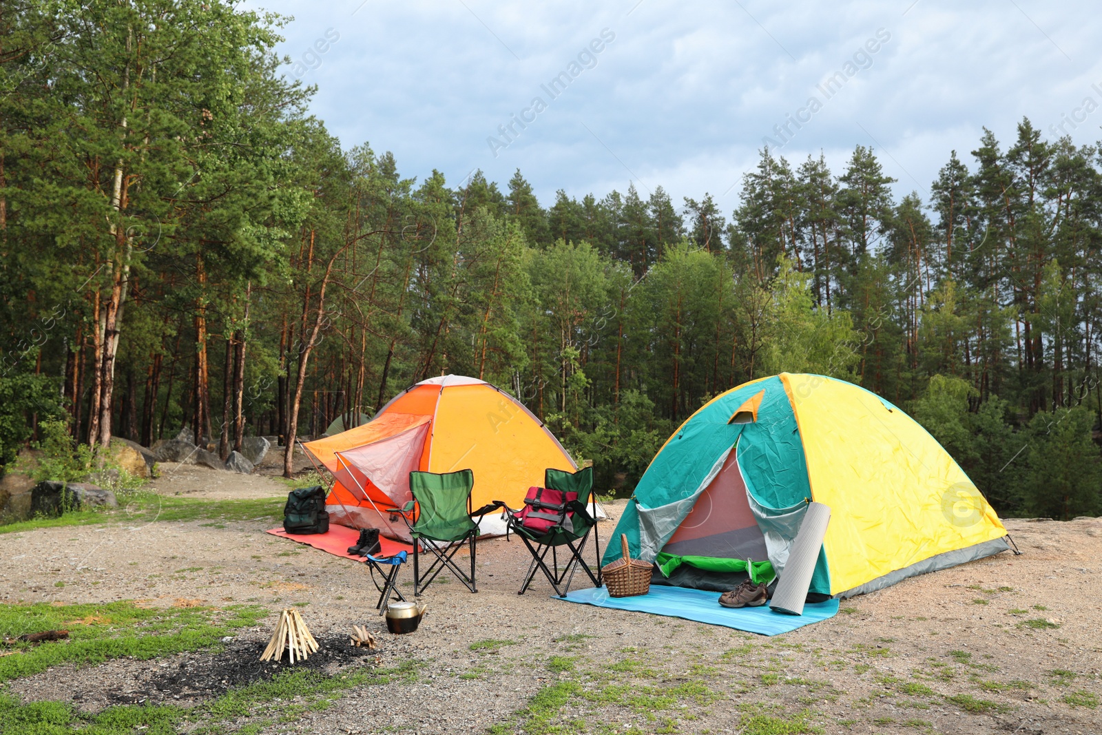 Photo of Camping tents and accessories in wilderness on summer day