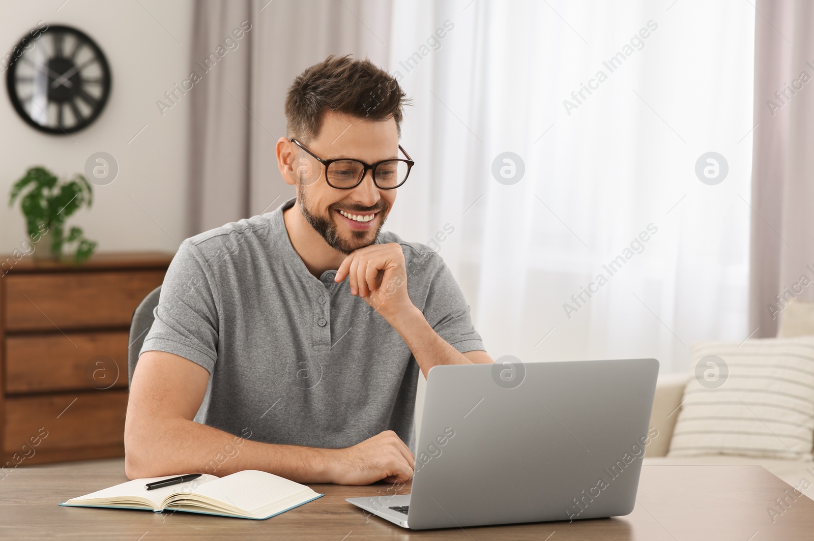 Photo of Man studying on laptop at home. Online translation course