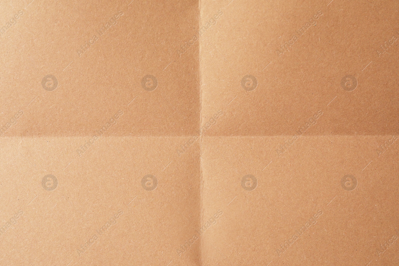 Photo of Folded kraft paper sheet as background, top view