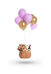 Image of Bunch of color balloons and wicker basket with different gifts on white background