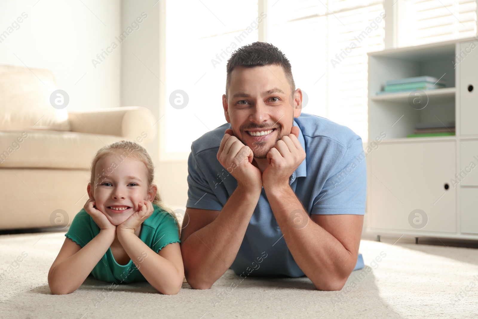 Photo of Dad and daughter spending time together at home. Happy Father's Day