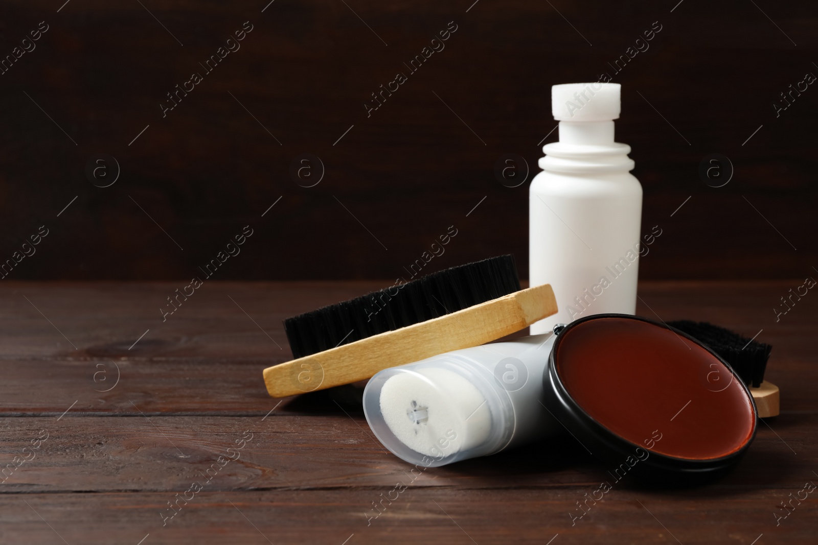 Photo of Composition with shoe care accessories on wooden table. Space for text