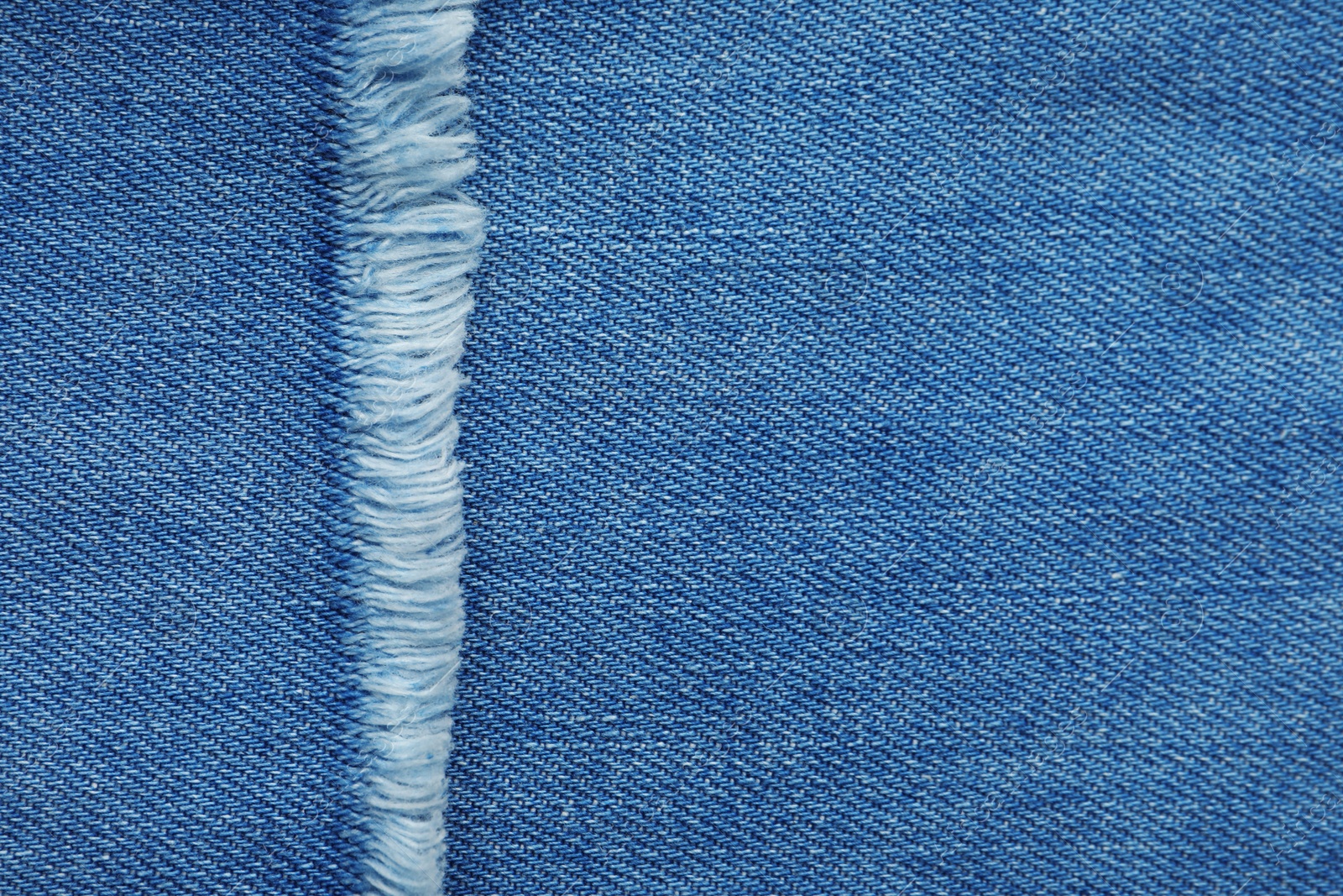 Photo of Texture of blue jeans as background, closeup