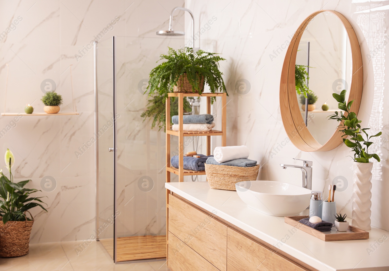 Photo of Stylish bathroom interior with countertop, shower stall and houseplants. Design idea