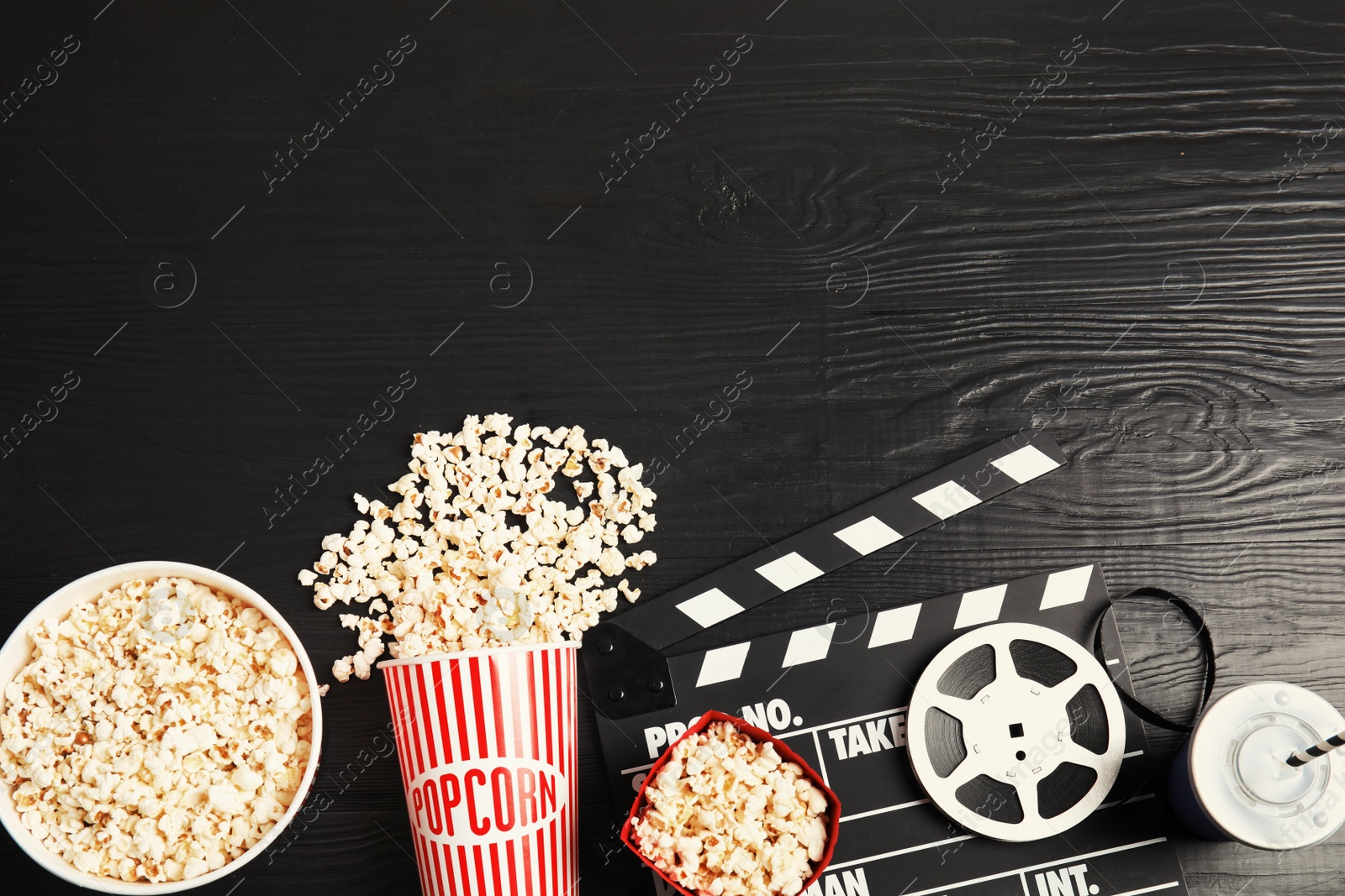 Photo of Flat lay composition with tasty popcorn and space for text on wooden background. Cinema snack