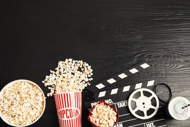 Photo of Flat lay composition with tasty popcorn and space for text on wooden background. Cinema snack