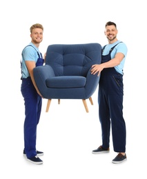 Portrait of moving service employees with armchair on white background