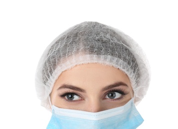 Young medical student with face mask and surgical cap on white background, closeup