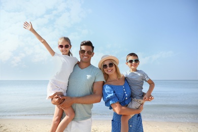 Photo of Happy family at beach on sunny summer day